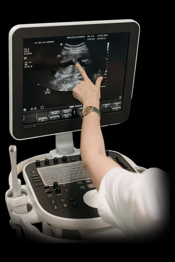 Sonographer operating an ultrasound machine